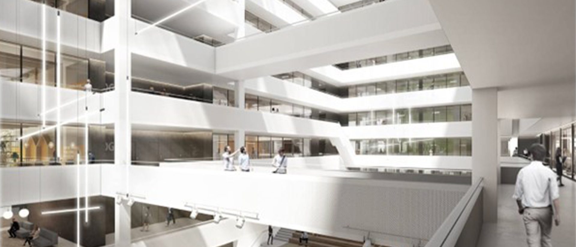 Modern multi-story office atrium with large windows, open walkways, white interiors, and a few people walking or talking.