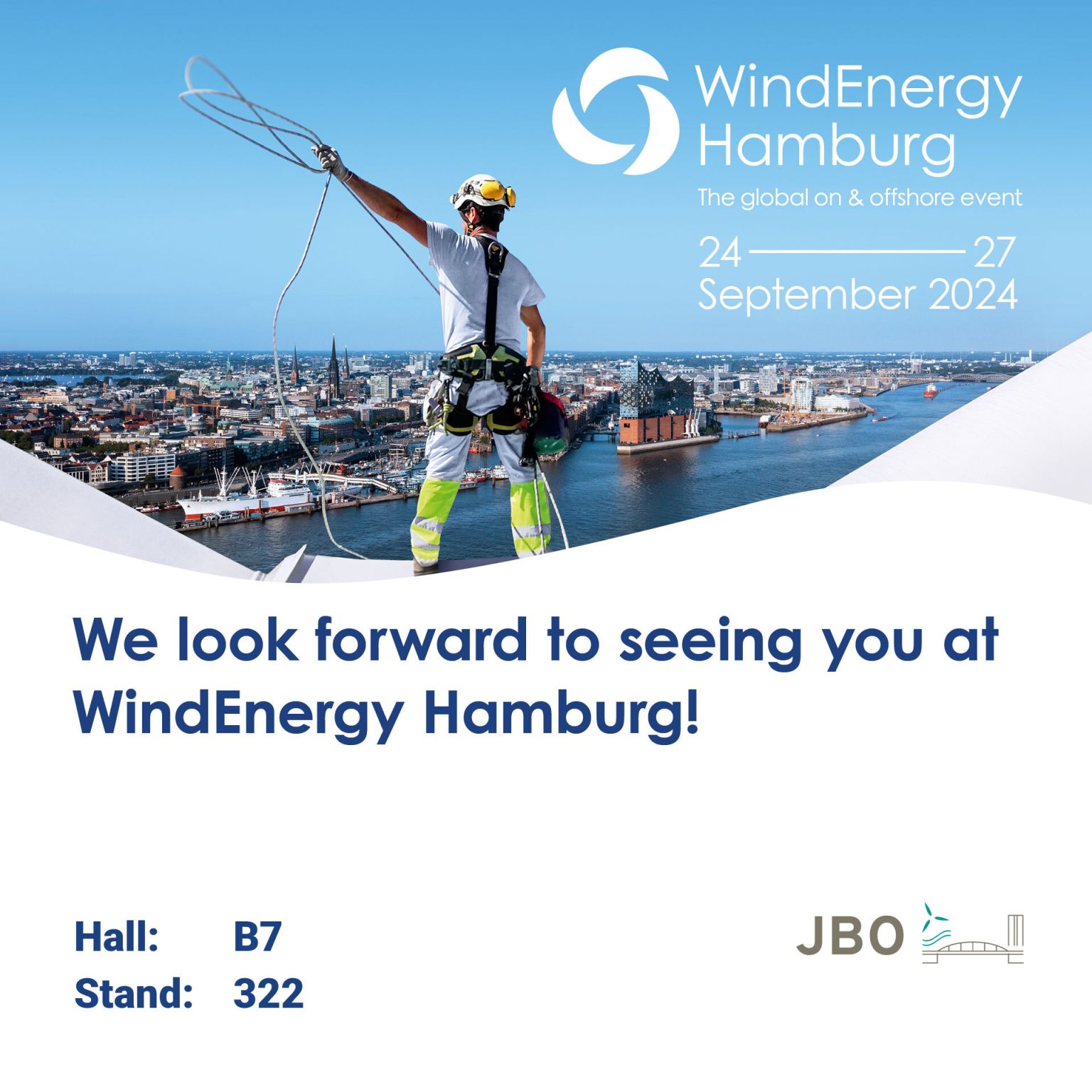 A worker in safety gear stands on a rooftop overlooking Hamburg, holding a rope, with event details for WindEnergy Hamburg 2024 overlaid on the image.